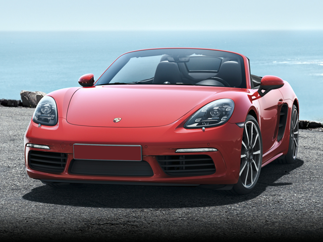 Guards Red 2024 Porsche 718 Boxster parked with ocean behind